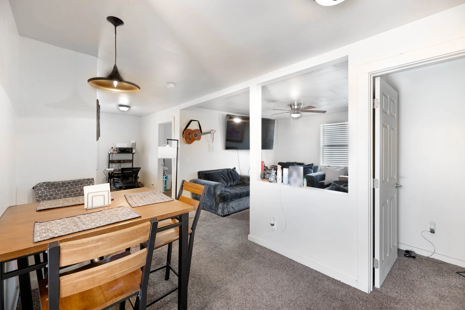 Apartment living and dining area with contemporary white walls