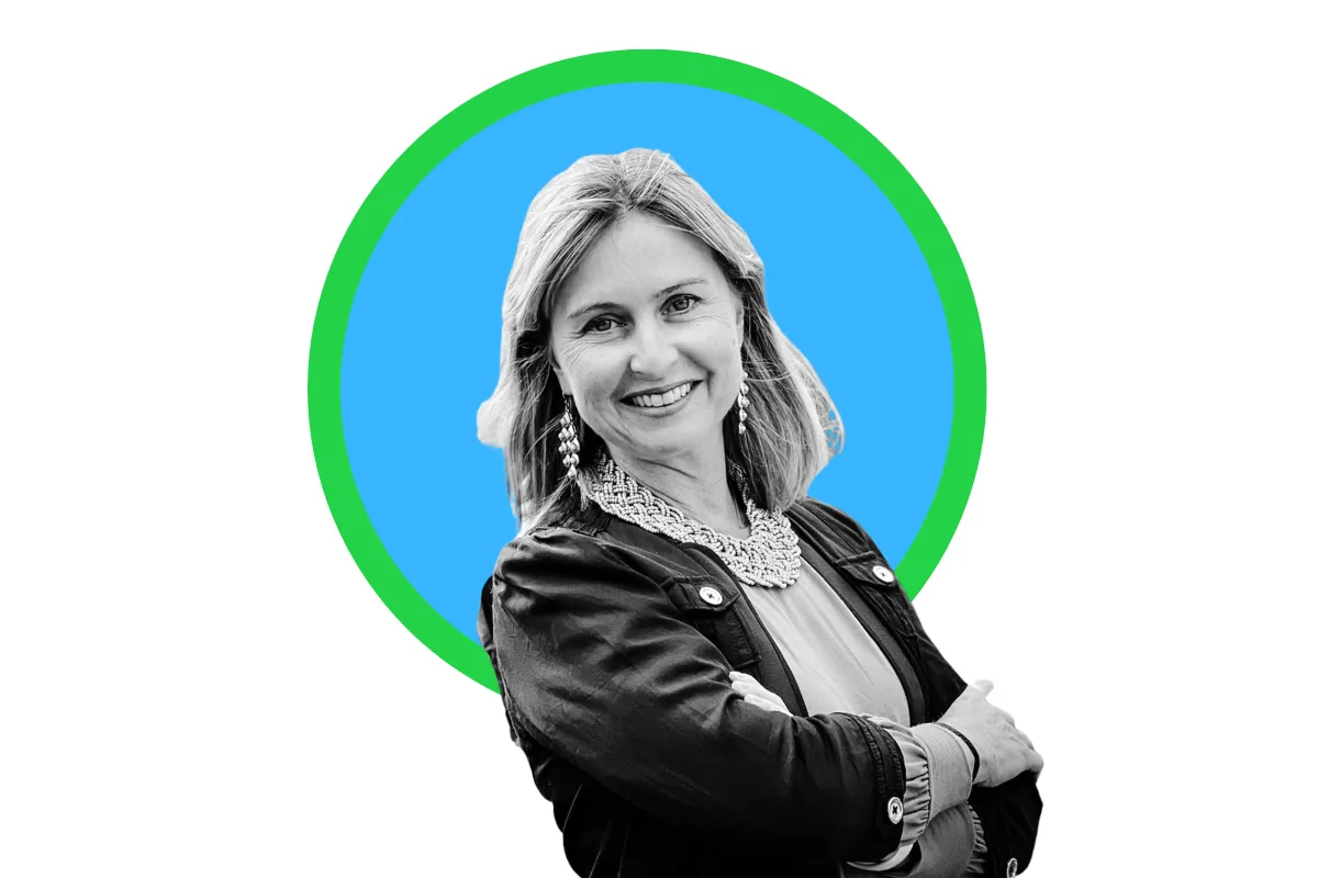 Kate Paulin headshot — smiling Realtor with blonde hair in a dark blazer against a blue background