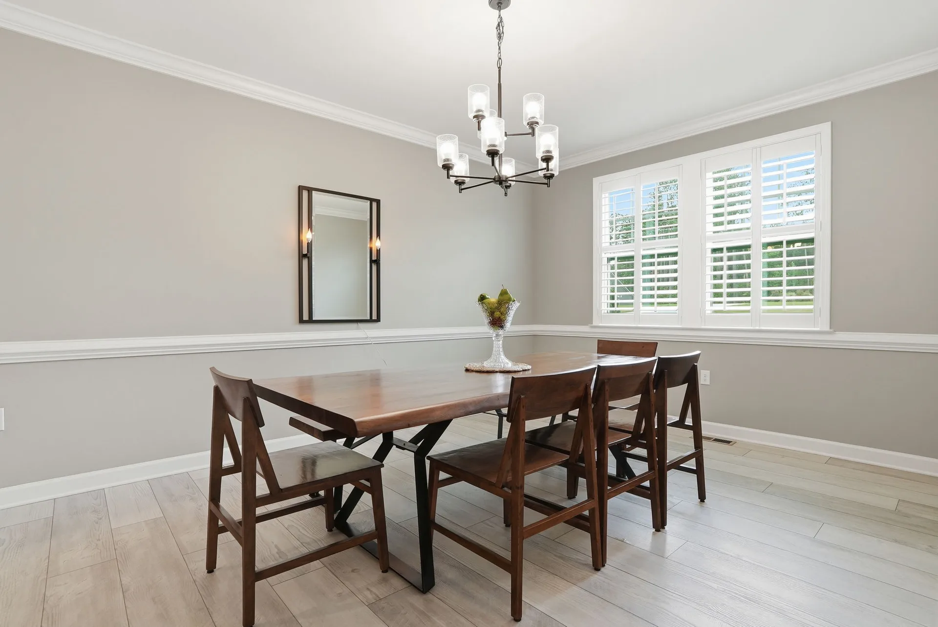 The formal dining room at 297 Bonaventure Dr, with chair rail molding and plantation shutters, ready for a holiday dinner table
