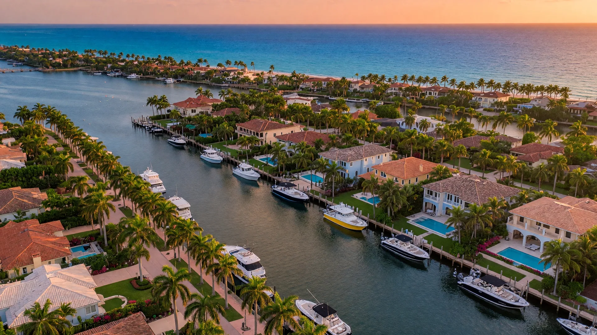 Aerial view of South Florida's coastal neighborhoods with waterfront homes, palm-lined streets, and the Intracoastal Waterway