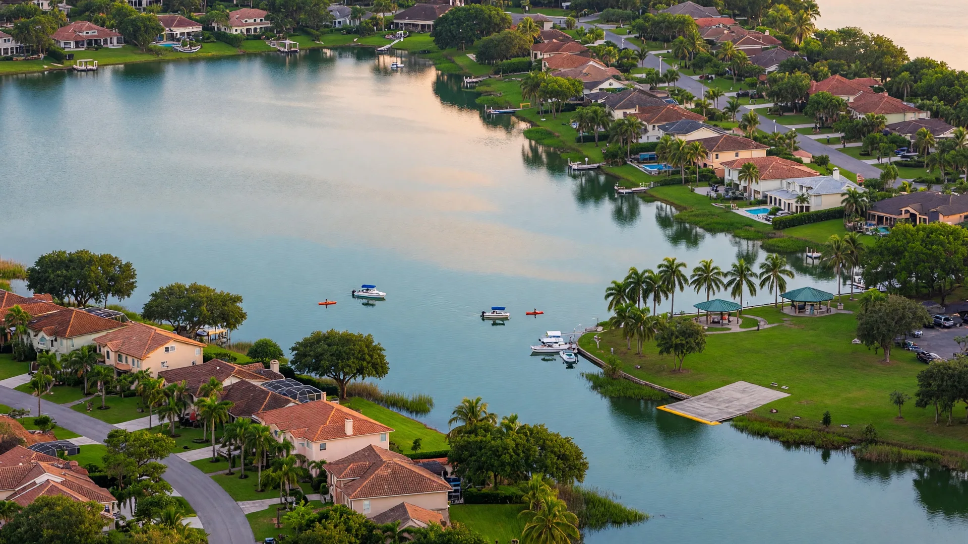 Aerial view of Lake Ida in Delray Beach, Florida, showing the freshwater lake surrounded by tree-lined residential streets and lush green landscapes