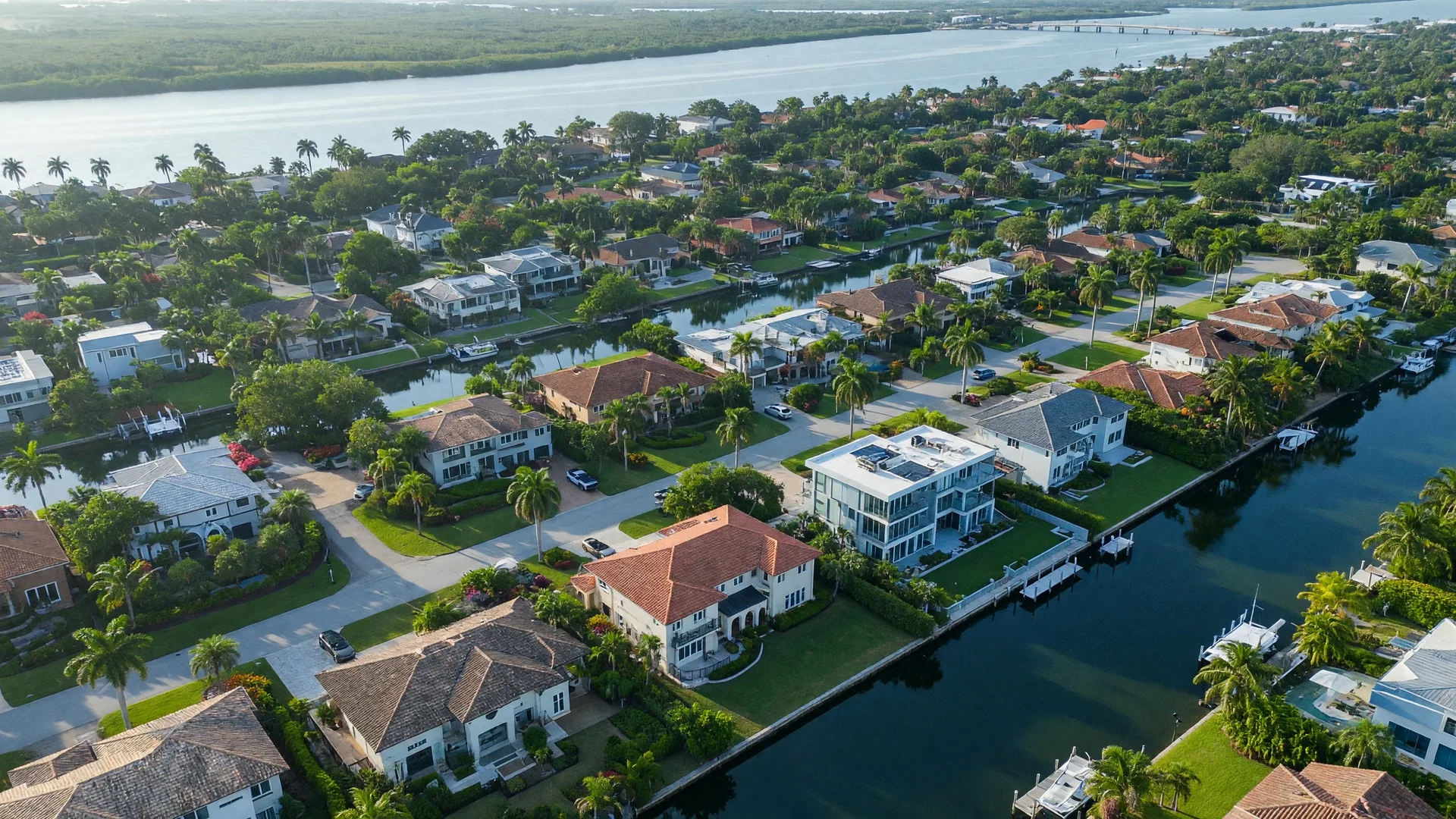 Aerial view of East Delray Beach residential subdivisions with tree-lined streets, canals, and tropical landscaping