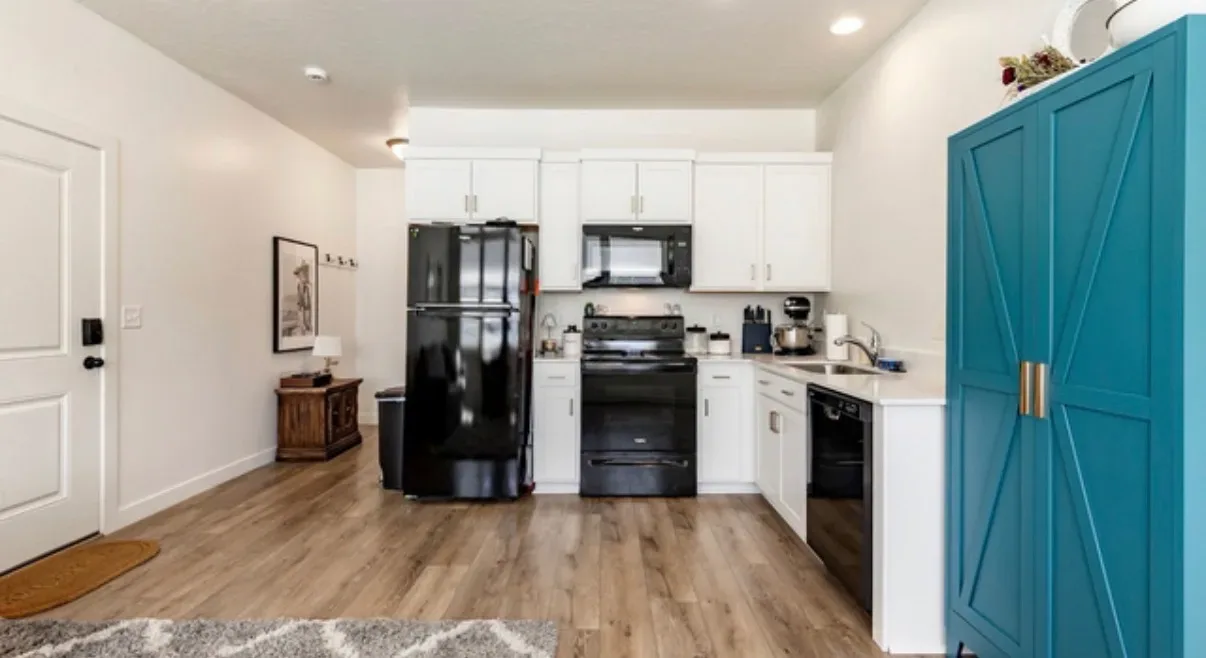 ADU kitchenette area with white cabinetry