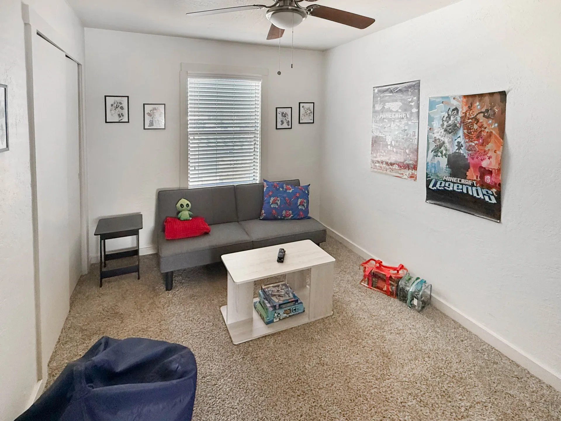 Apartment bedroom with white walls and beige carpeting