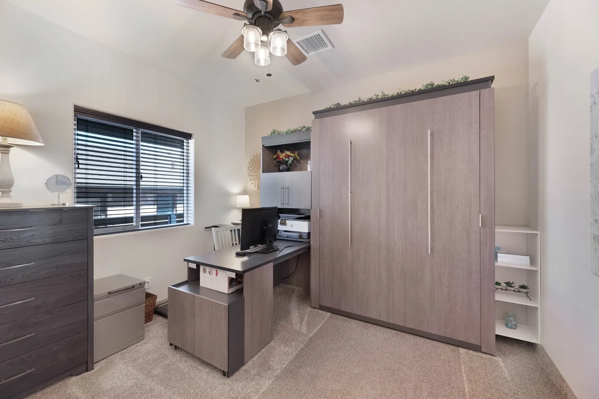 Multi-functional flex space with Murphy bed unit, desk, and office furniture