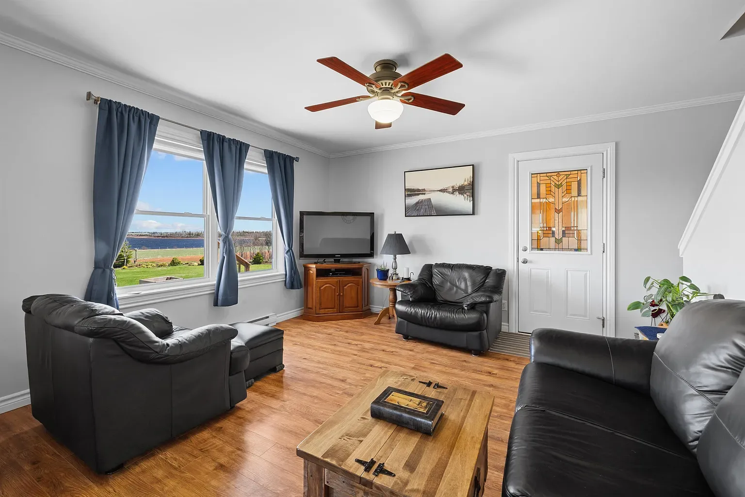 Living room featuring water views through large windows