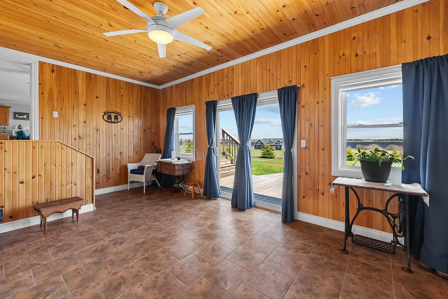 Bright sunroom with knotty pine walls