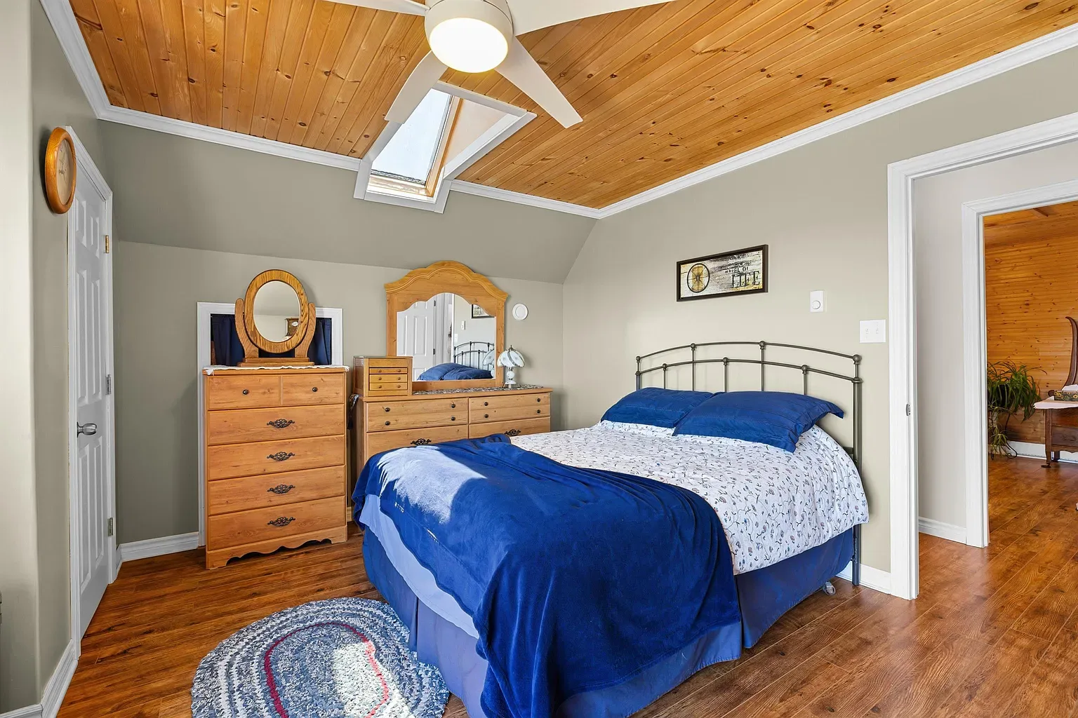 Master bedroom with slanted ceiling and skylight