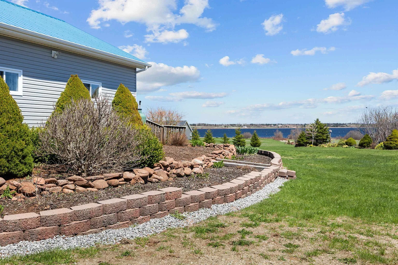 Landscaped backyard with coastal views