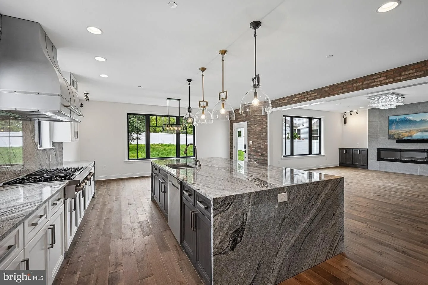 Chef-inspired kitchen with dual waterfall granite island