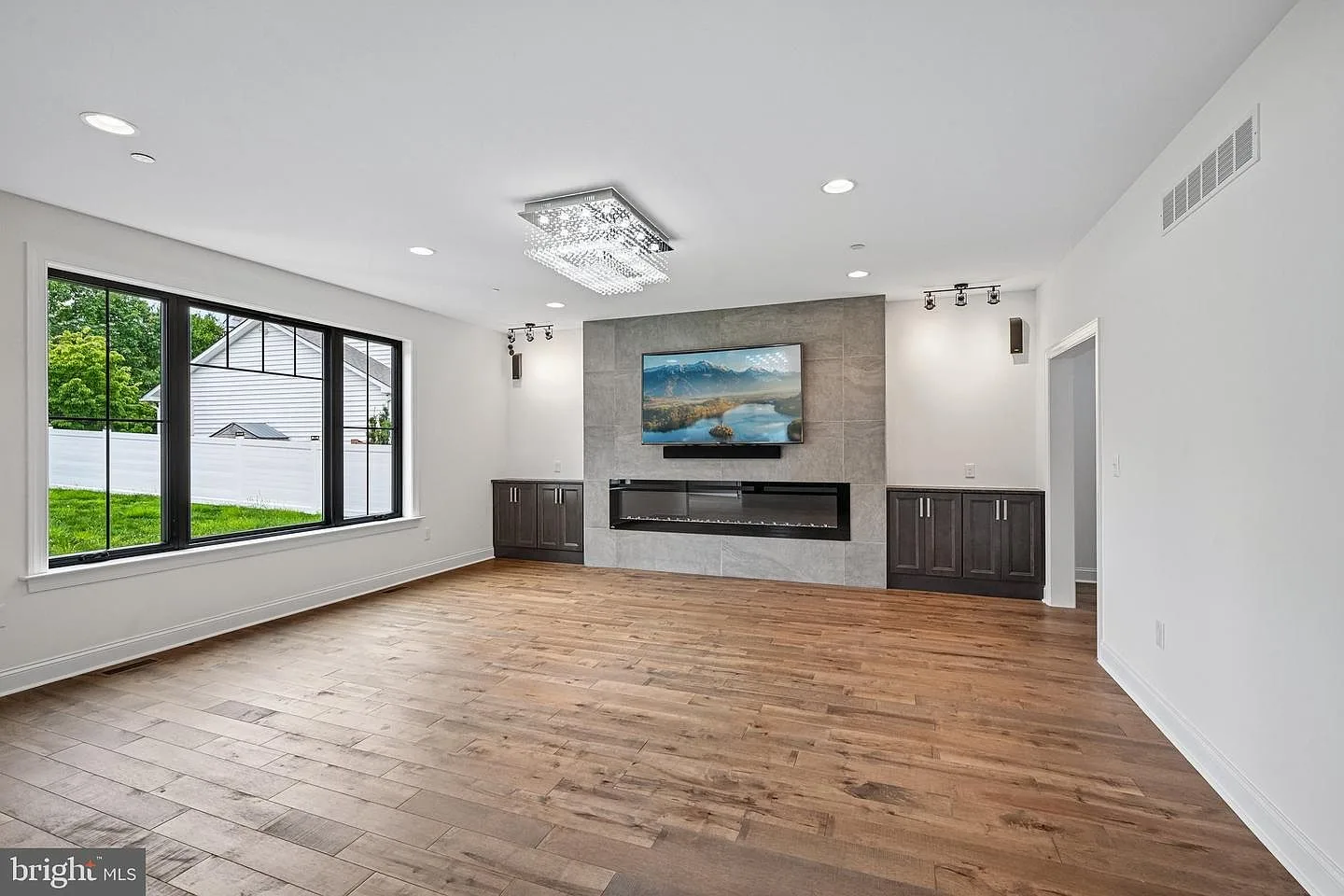 Living room with custom built-ins and leathered granite