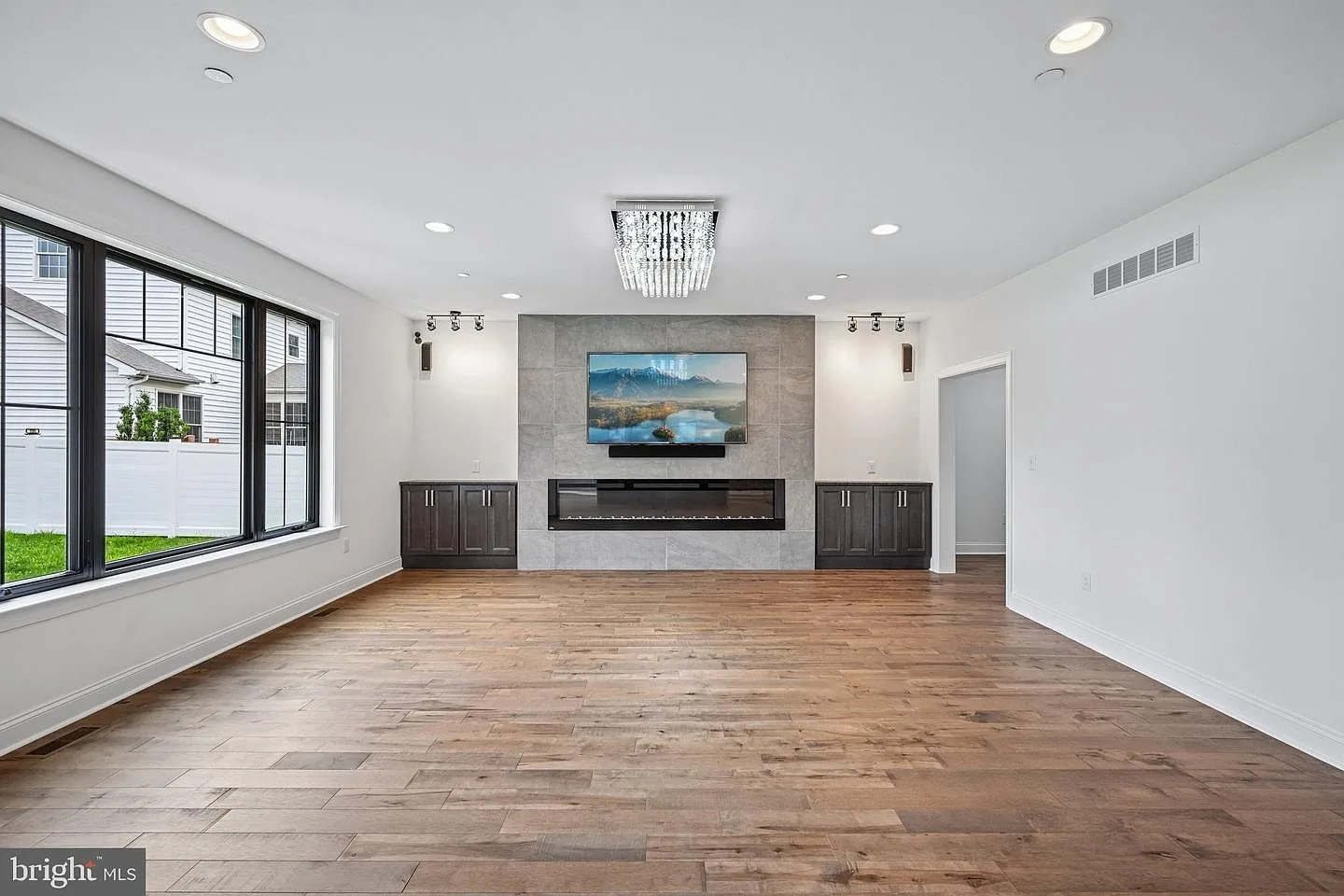 Great room with Napoleon linear fireplace and custom built-ins
