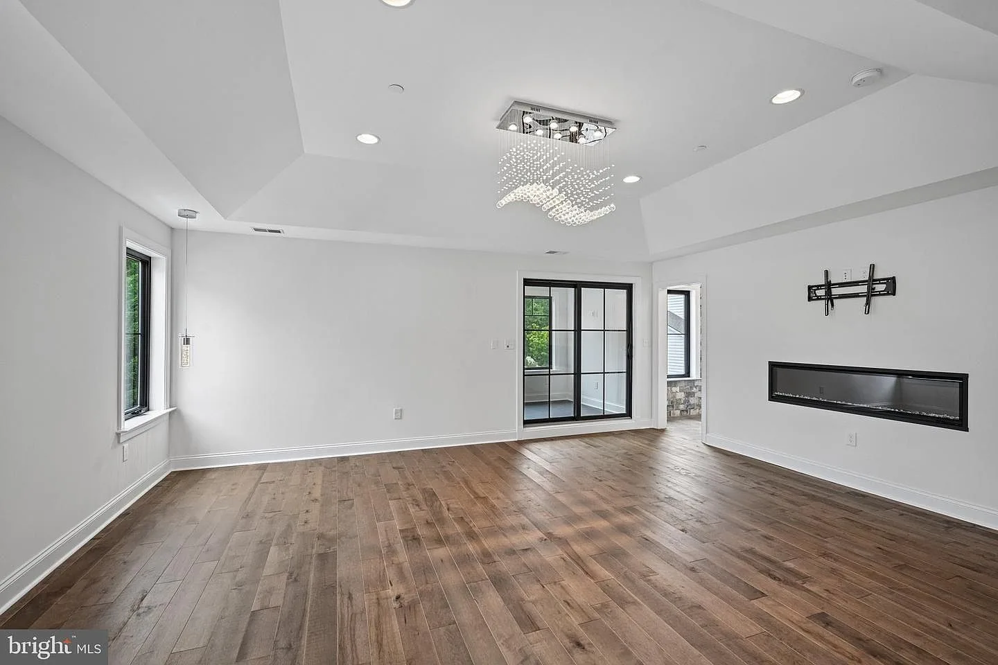 Primary suite with tray ceilings and fireplace
