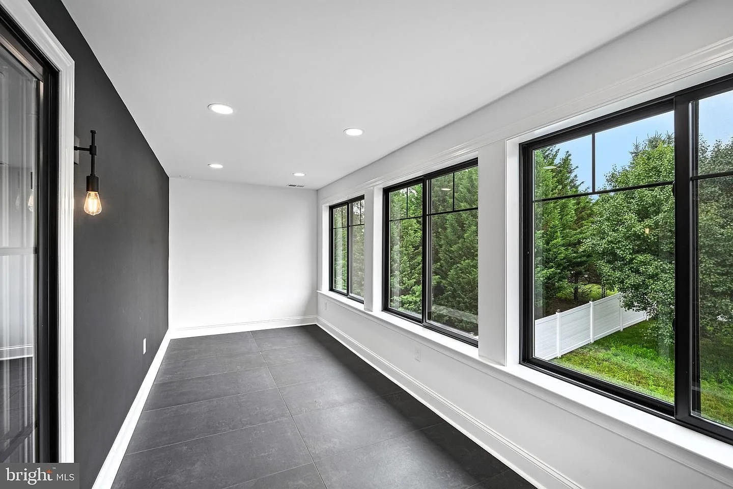 All-season enclosed balcony overlooking backyard