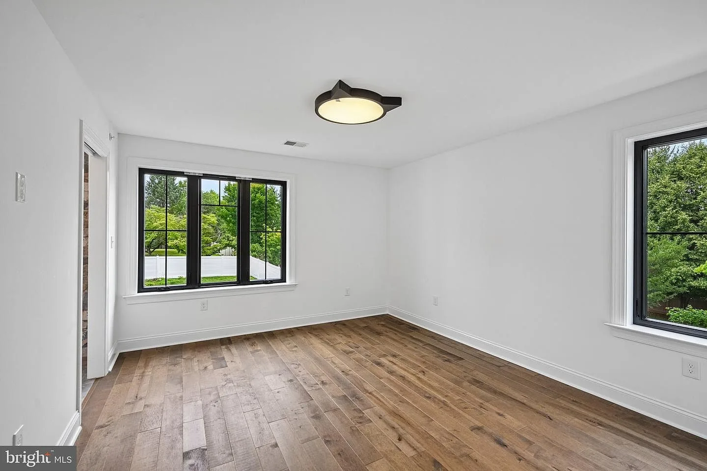 Secondary bedroom with maple hardwood floors