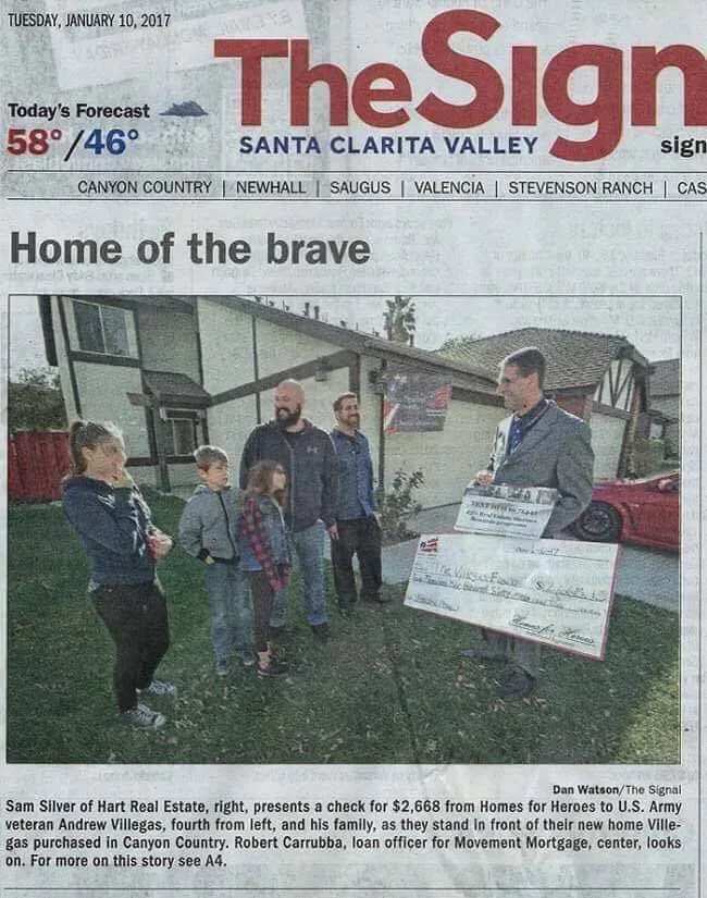 Sam Silver presenting a $2,668 Sam's Heroes rebate check to U.S. Army veteran Andrew Villegas in front of his new Canyon Country home, as featured in The Signal newspaper
