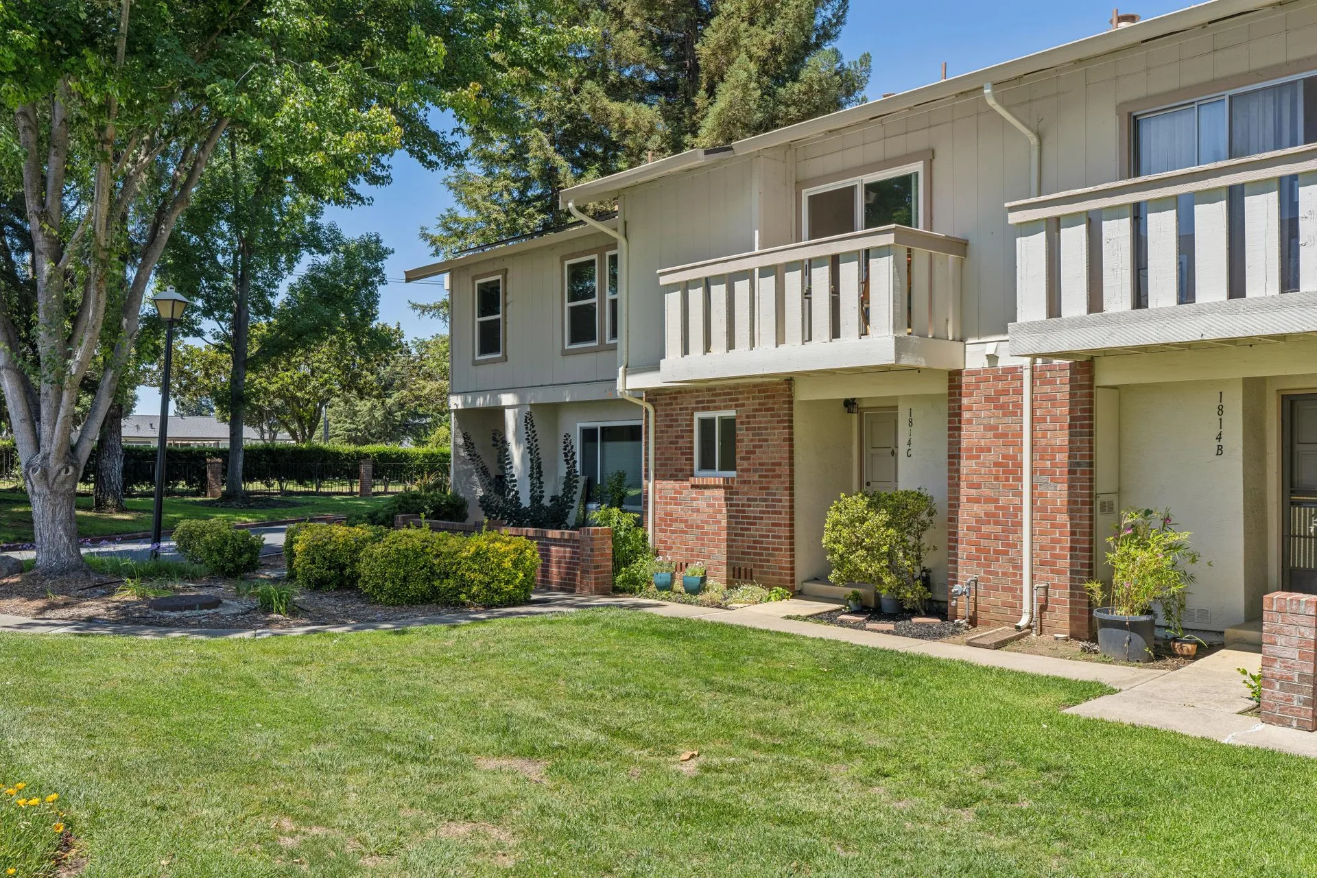 Exterior of 1814 Wildbrook Ct, a charming two-story townhome in the Oak Glen community of Concord, CA with mature trees and manicured lawn