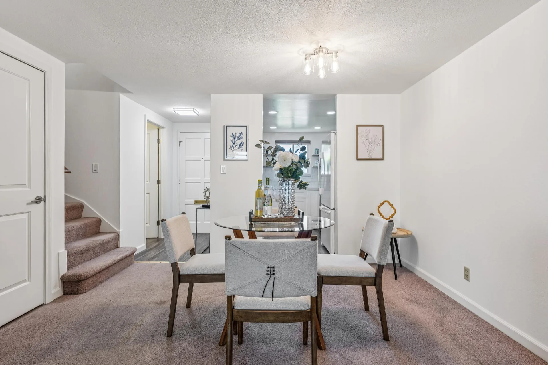 Dining room with glass-top table looking toward the kitchen area