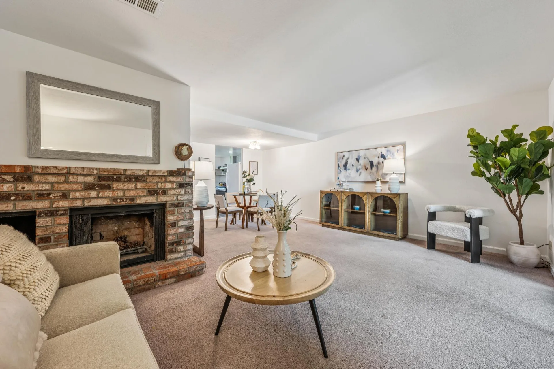 Living room and dining area with natural daylight and sliding patio doors