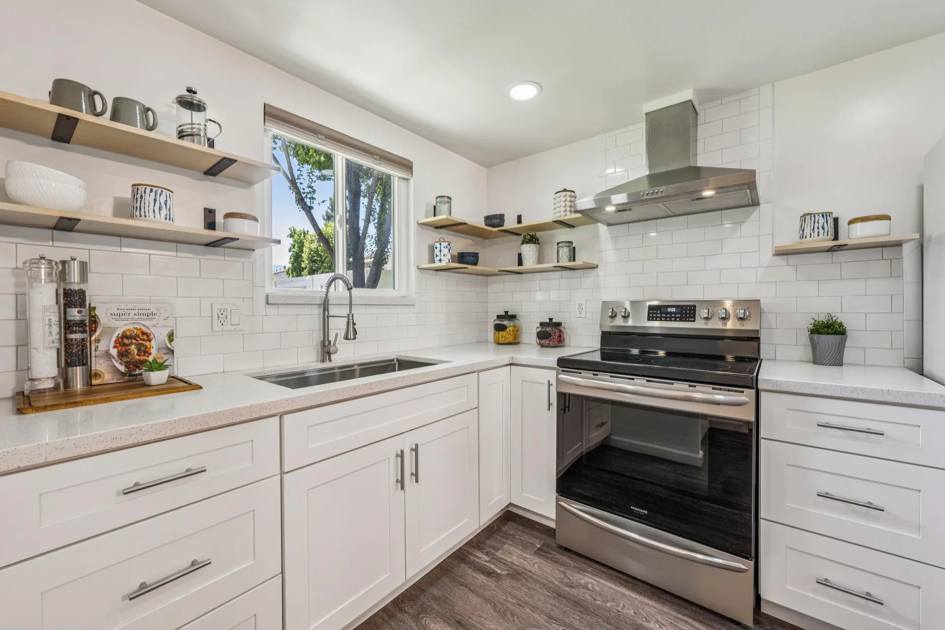 Updated kitchen with stainless steel appliances and butcher block shelving