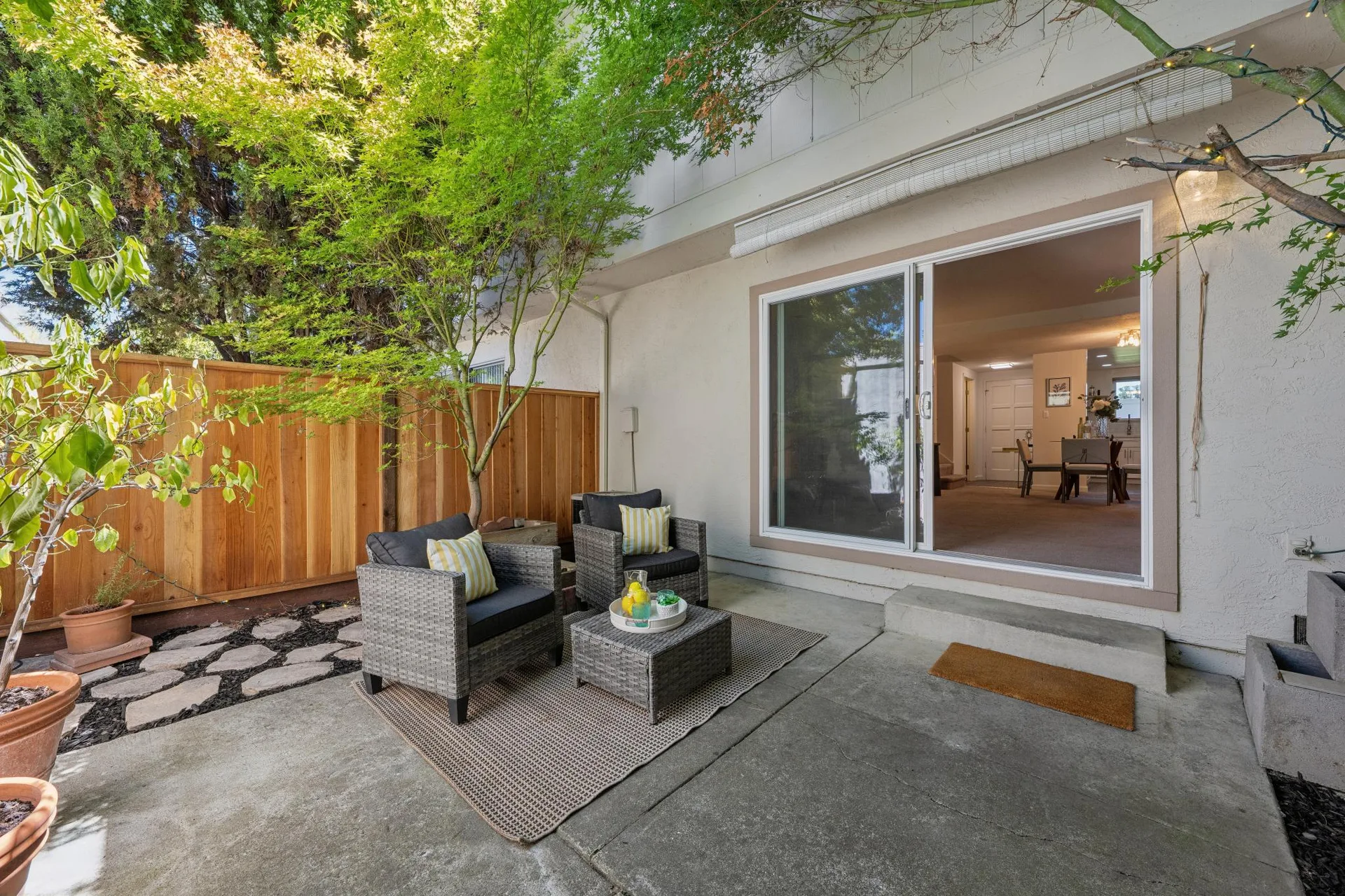Patio with string lights, water feature, and outdoor seating
