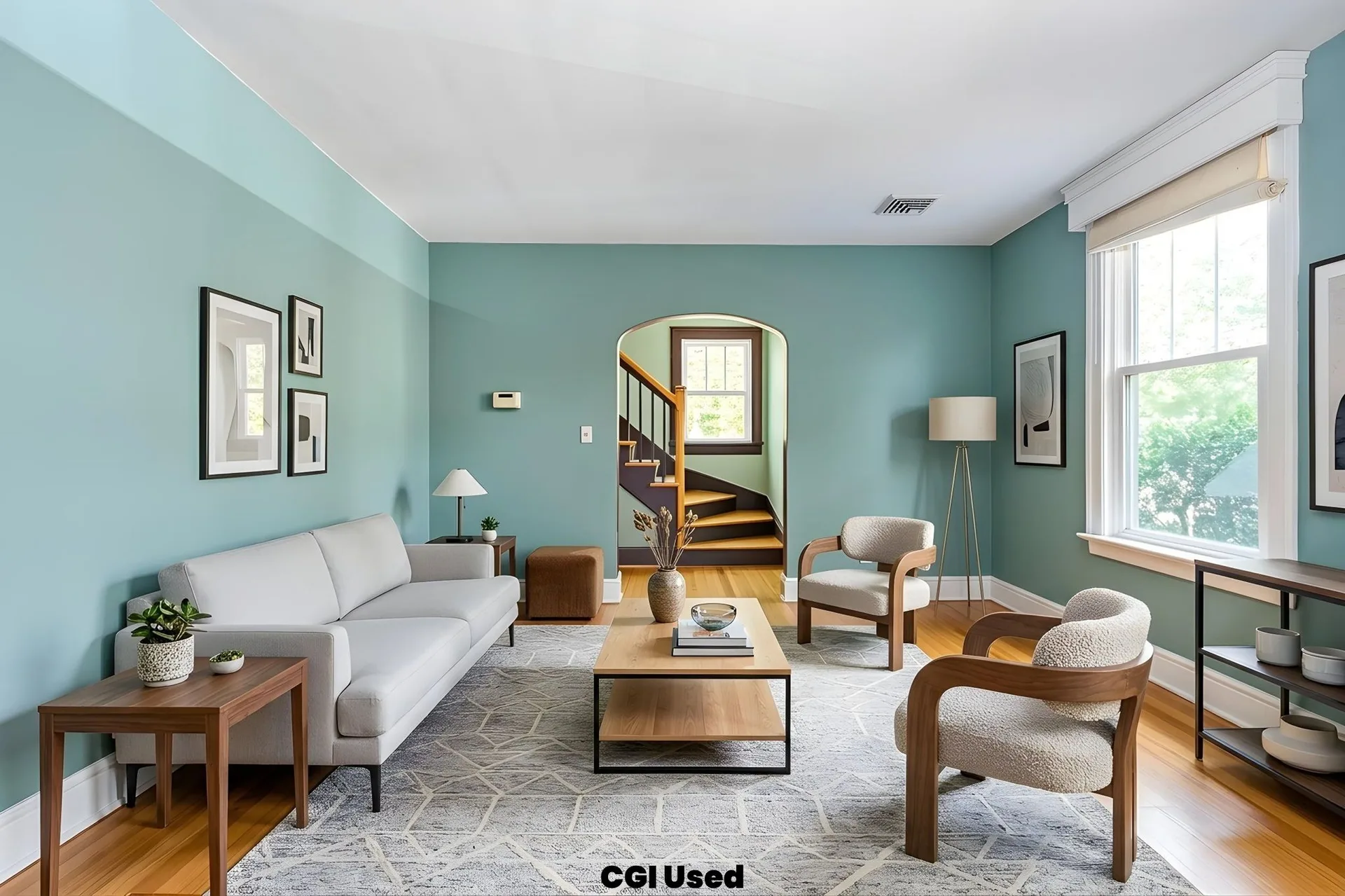 Staged living room with sofa, accent chairs, and archway detail