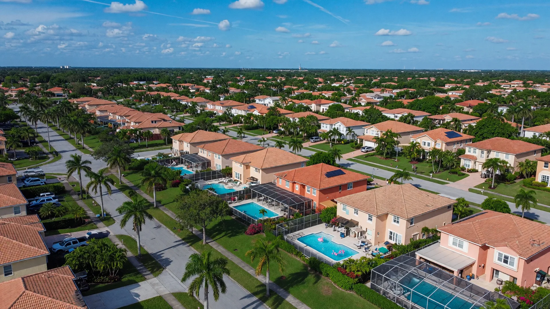 Aerial view of West Boca Raton residential neighborhoods with modern homes, pools, and palm trees