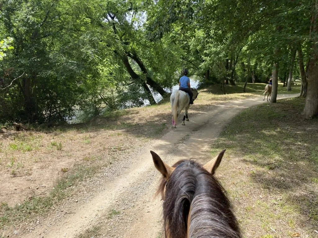Residents riding horses along a scenic trail through the Portofino community
