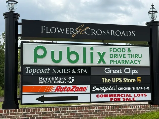 Flowers Crossroads community shopping center sign displaying tenant directory