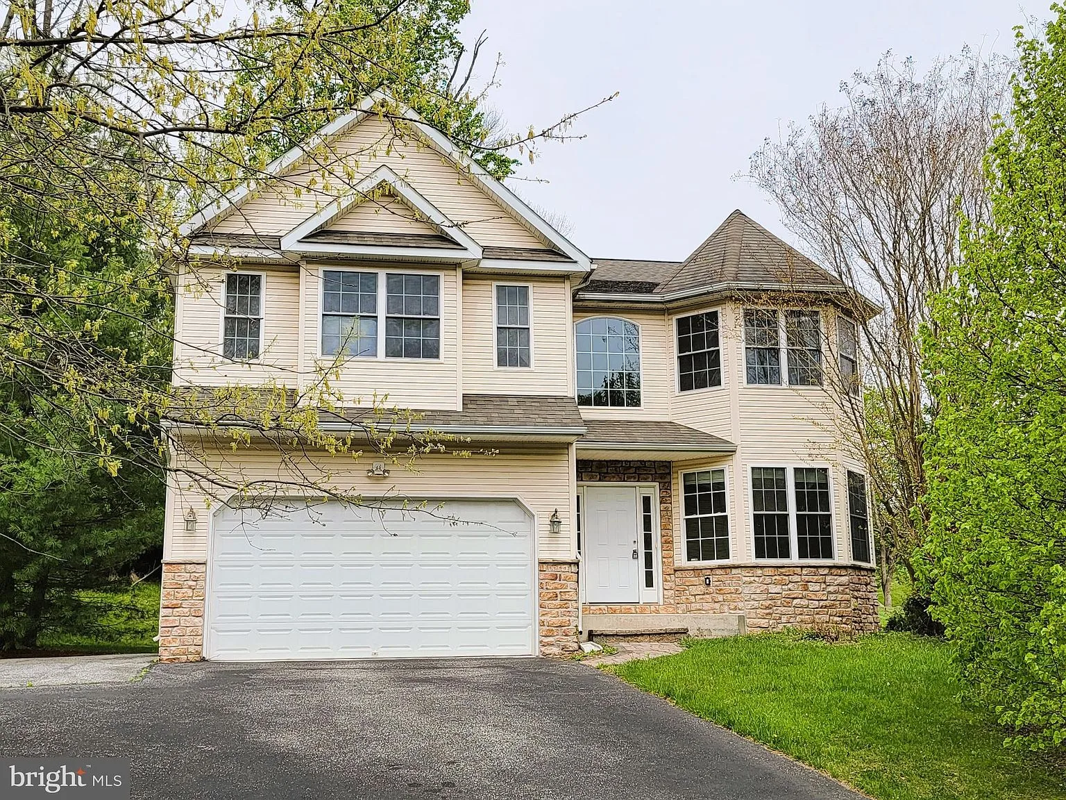 Front facade with vinyl siding and stone accents