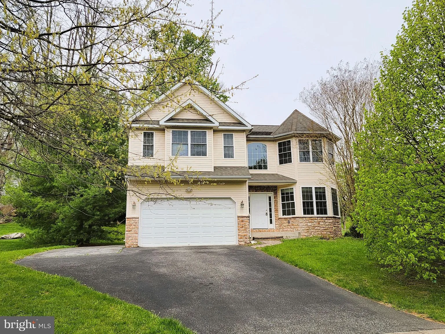 Front facade with double garage and mature landscaping