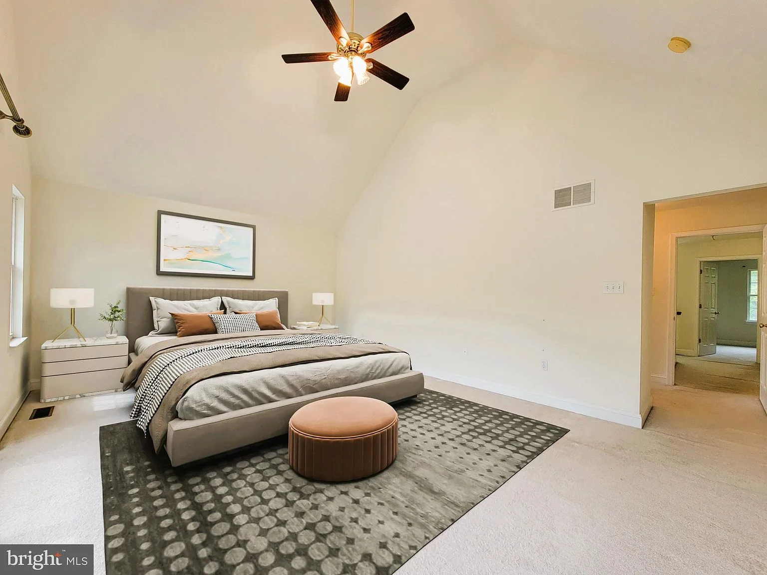 Primary bedroom with vaulted ceiling and furnishings