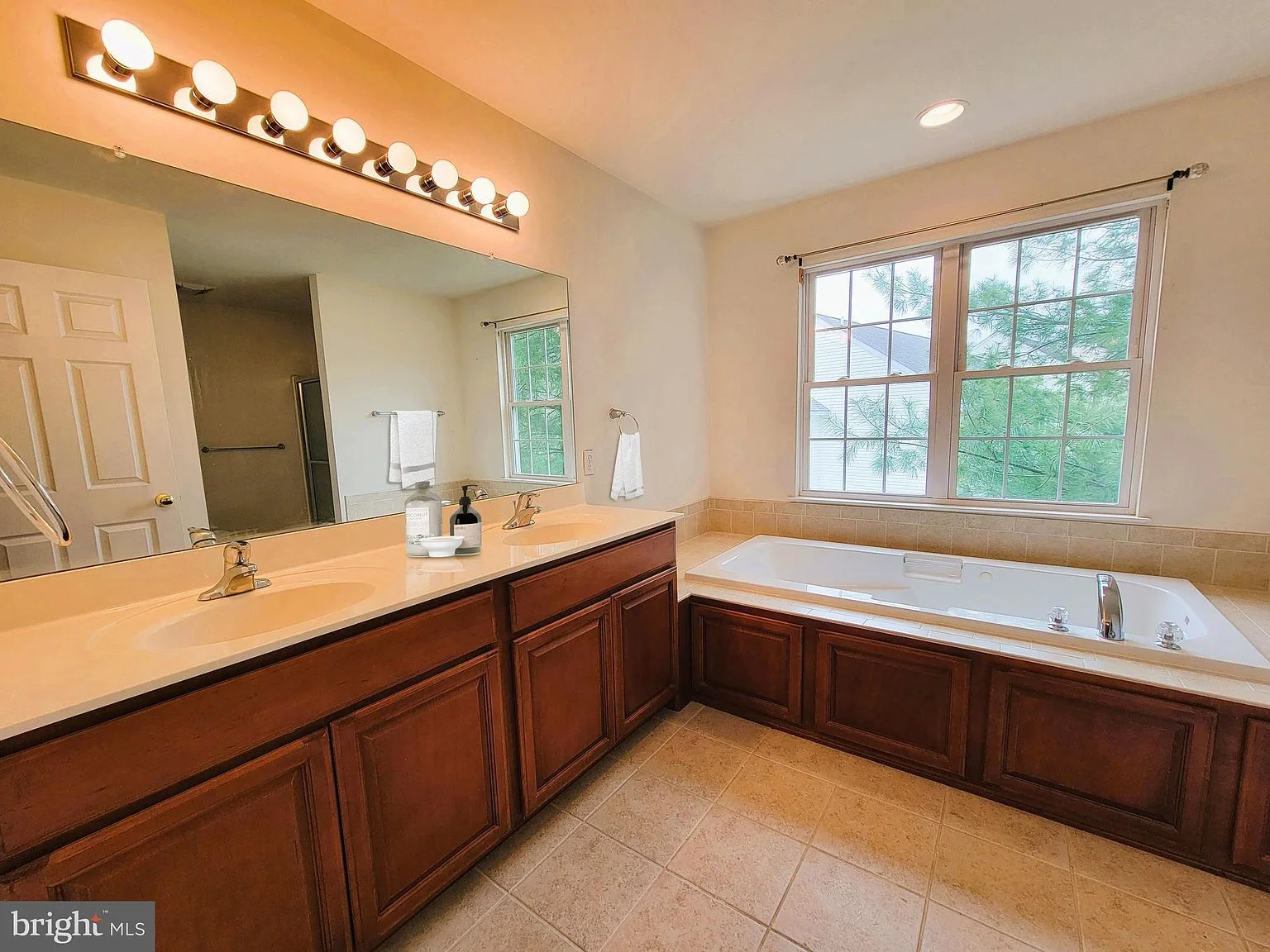 Primary bathroom with wood vanity