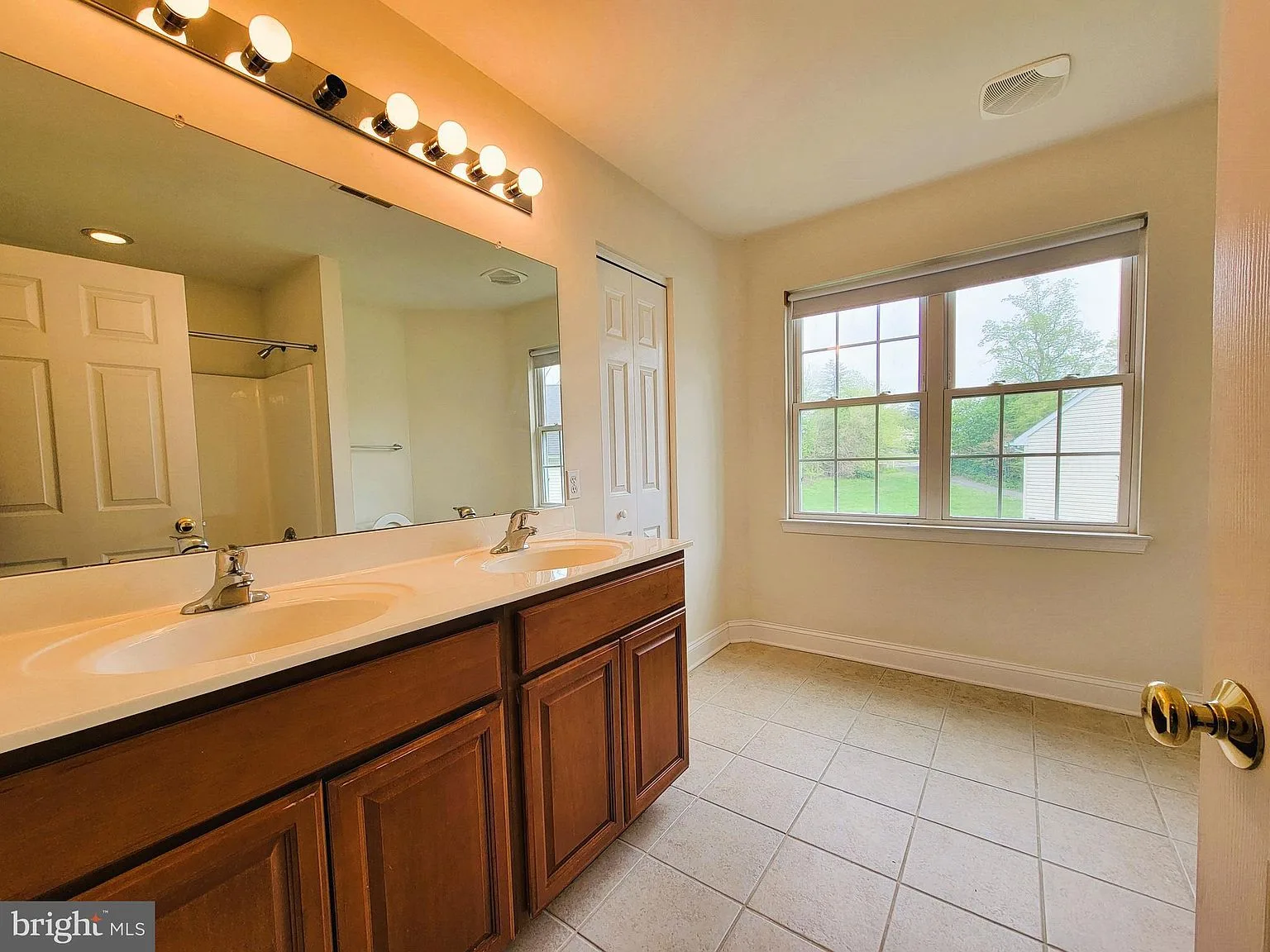 Dual vanity bathroom with natural light