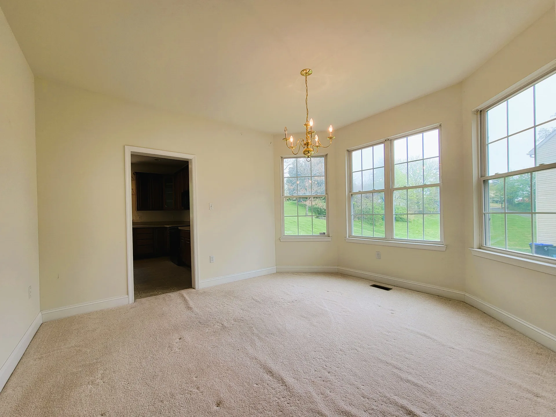 Dining room with chandelier and bay windows