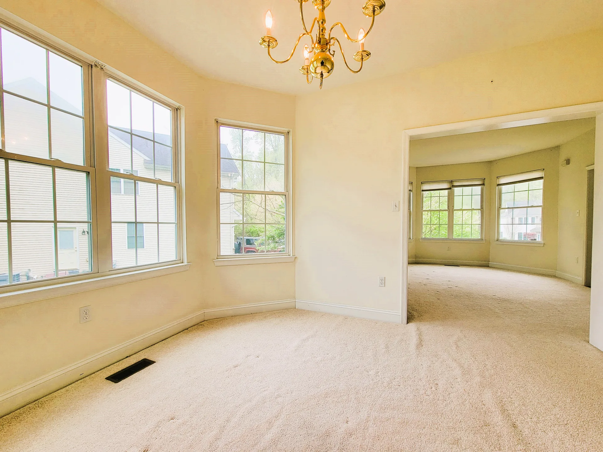 Dining area with bay windows looking to living area