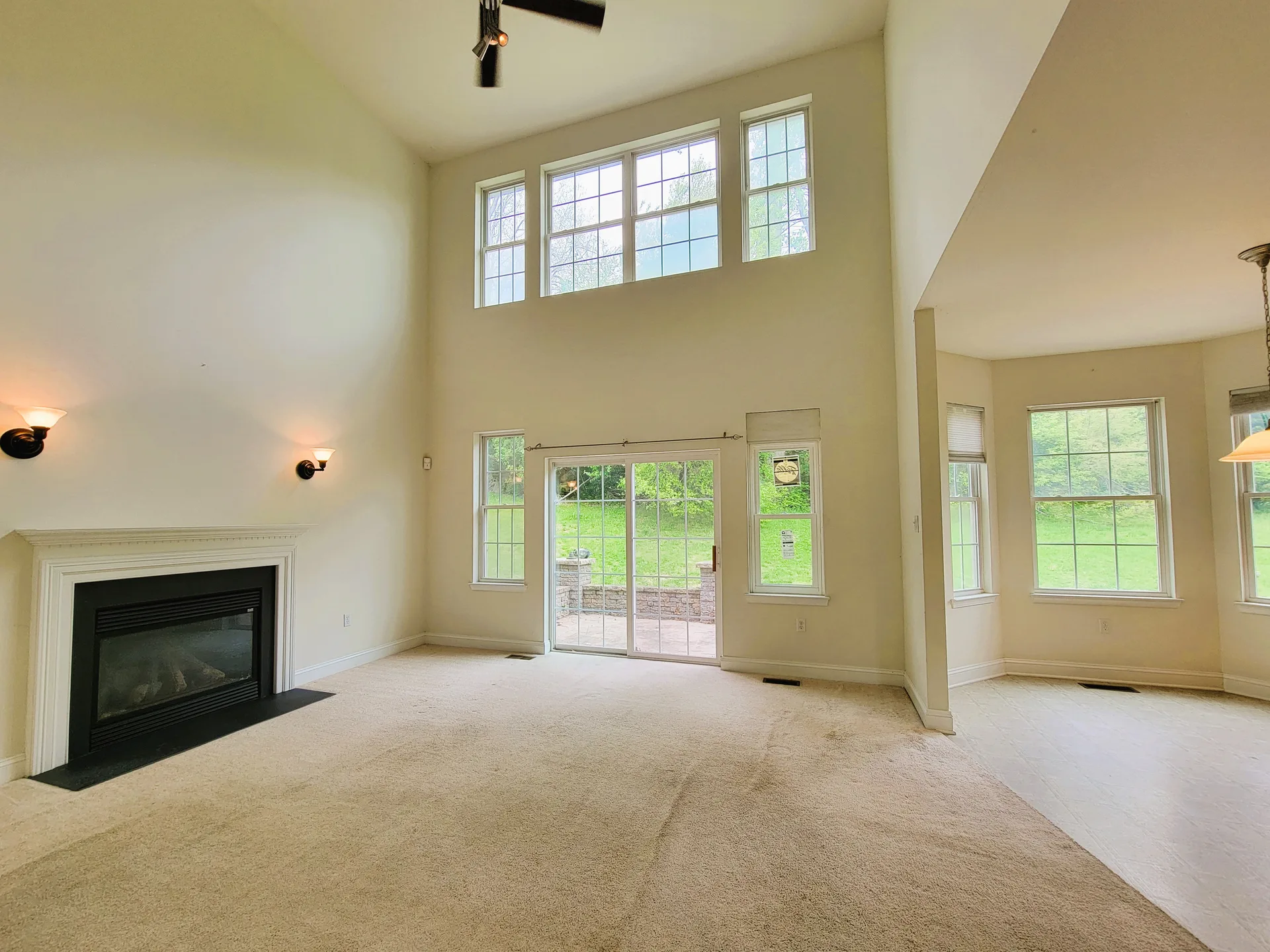 Living room with fireplace and high ceilings