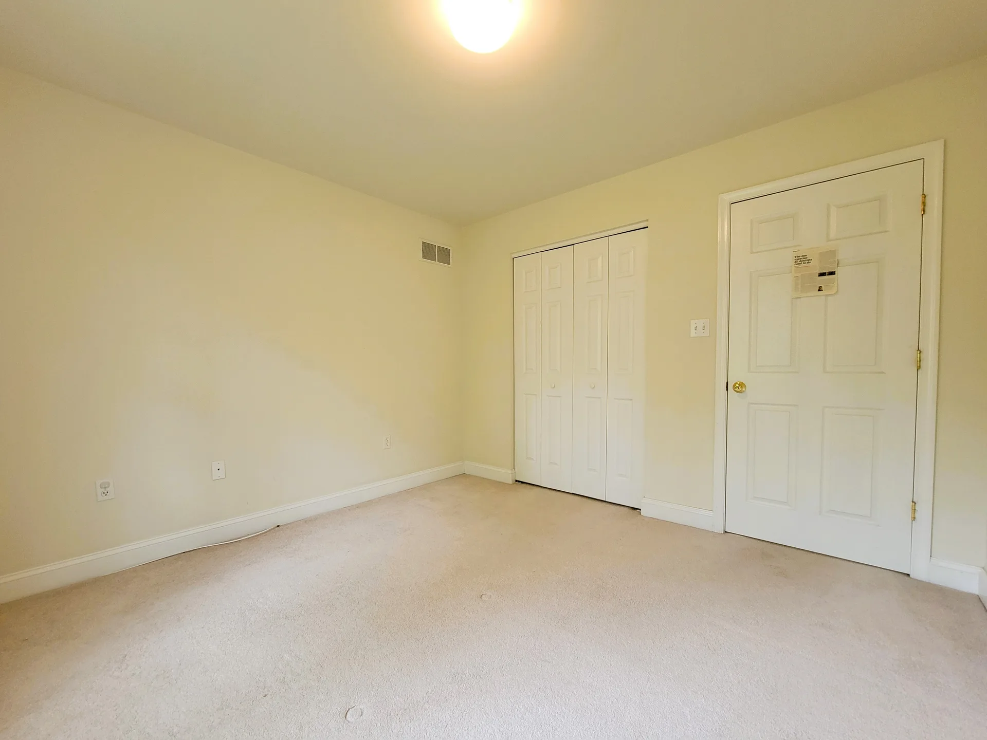 Vacant bedroom with beige walls