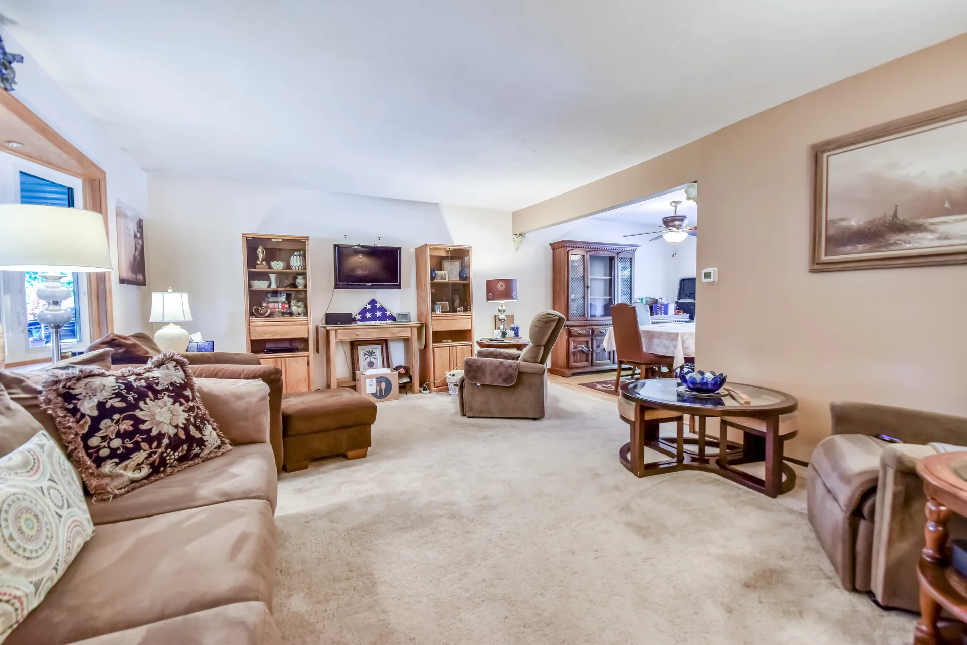 Open living and dining area with neutral walls