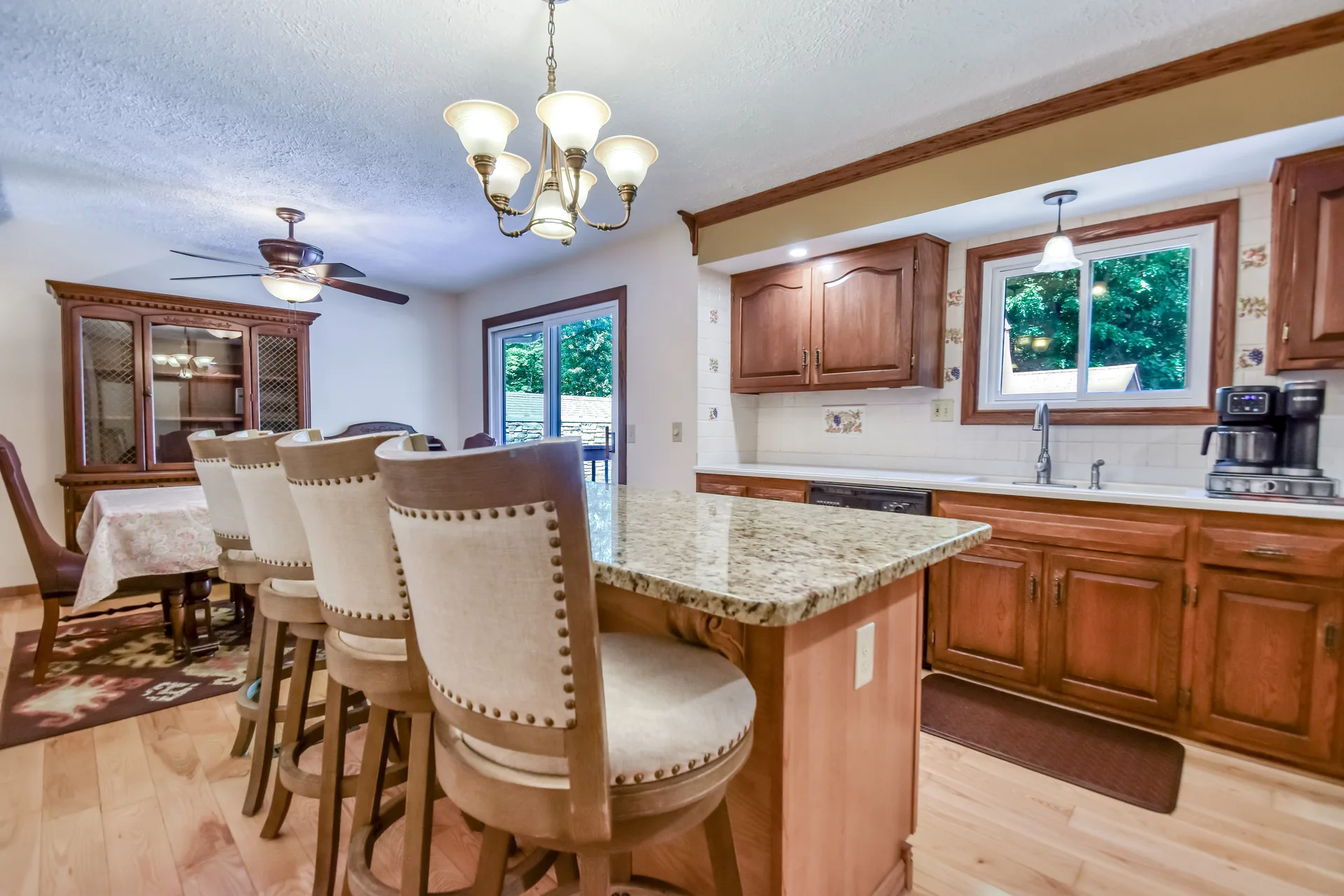 Open kitchen and dining area with island and wood cabinetry