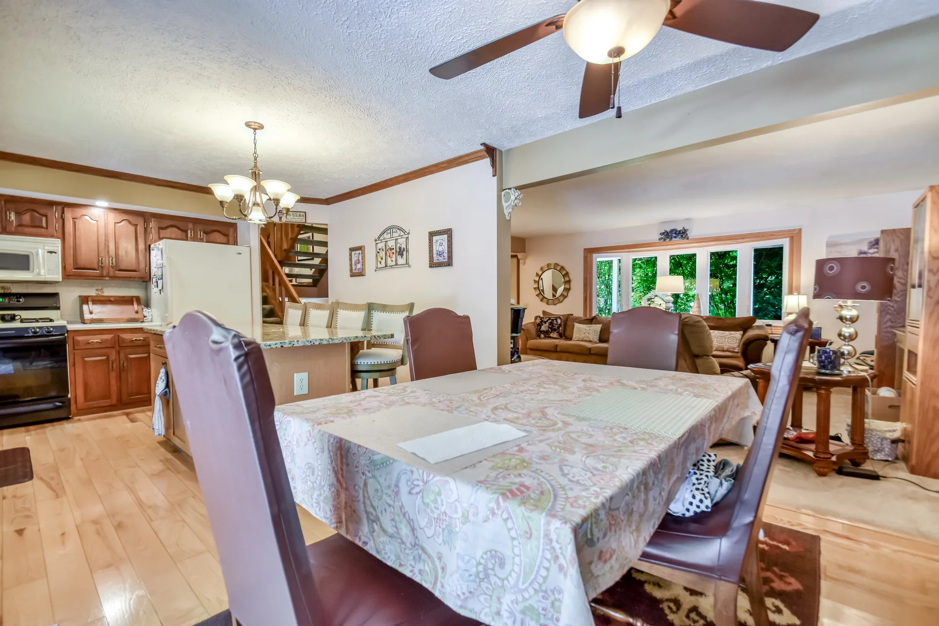 Dining area opening into living room and kitchen