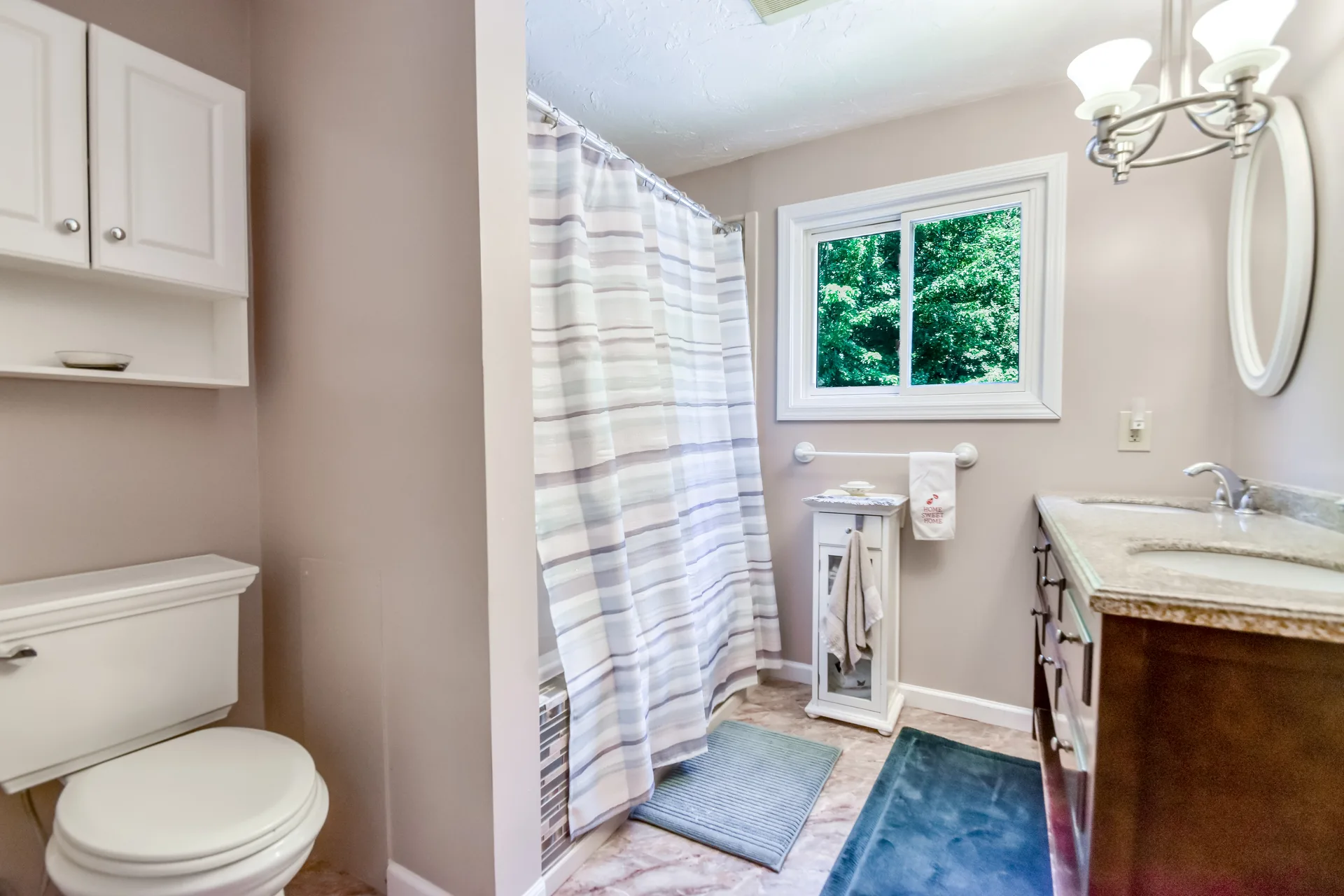 Guest bathroom with stone-topped vanity and natural daylight