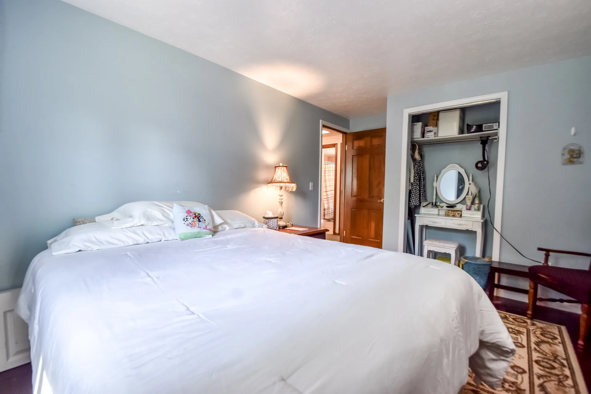Bedroom with bed, nightstand, and vanity table