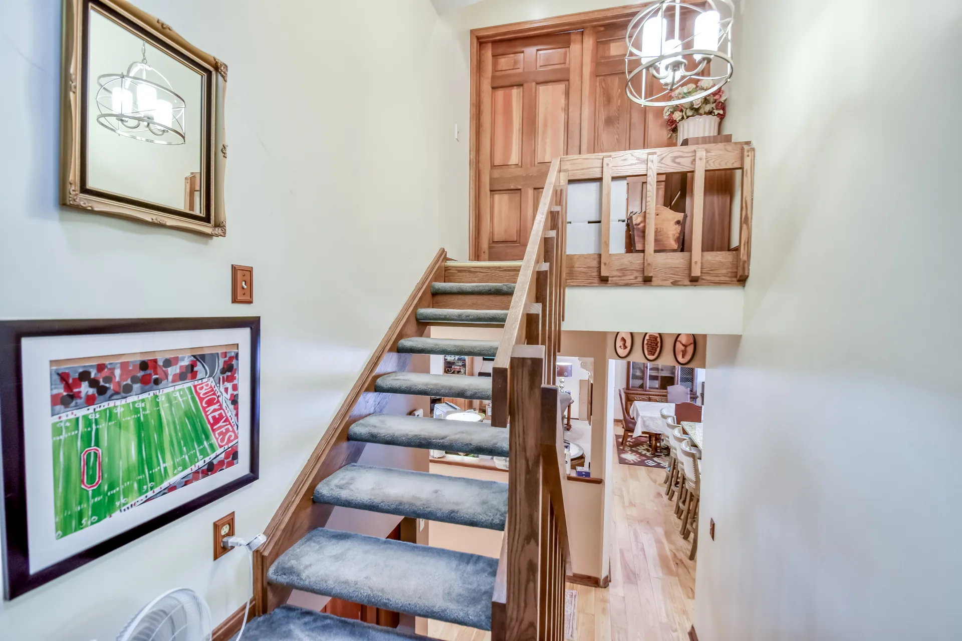 Entryway with split-level staircase and wood railings