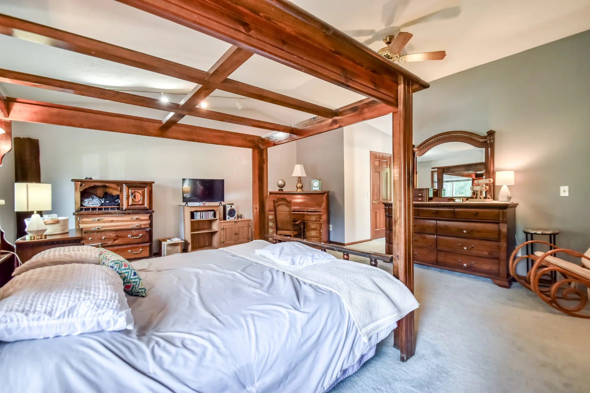 Master bedroom with four-poster bed and natural light