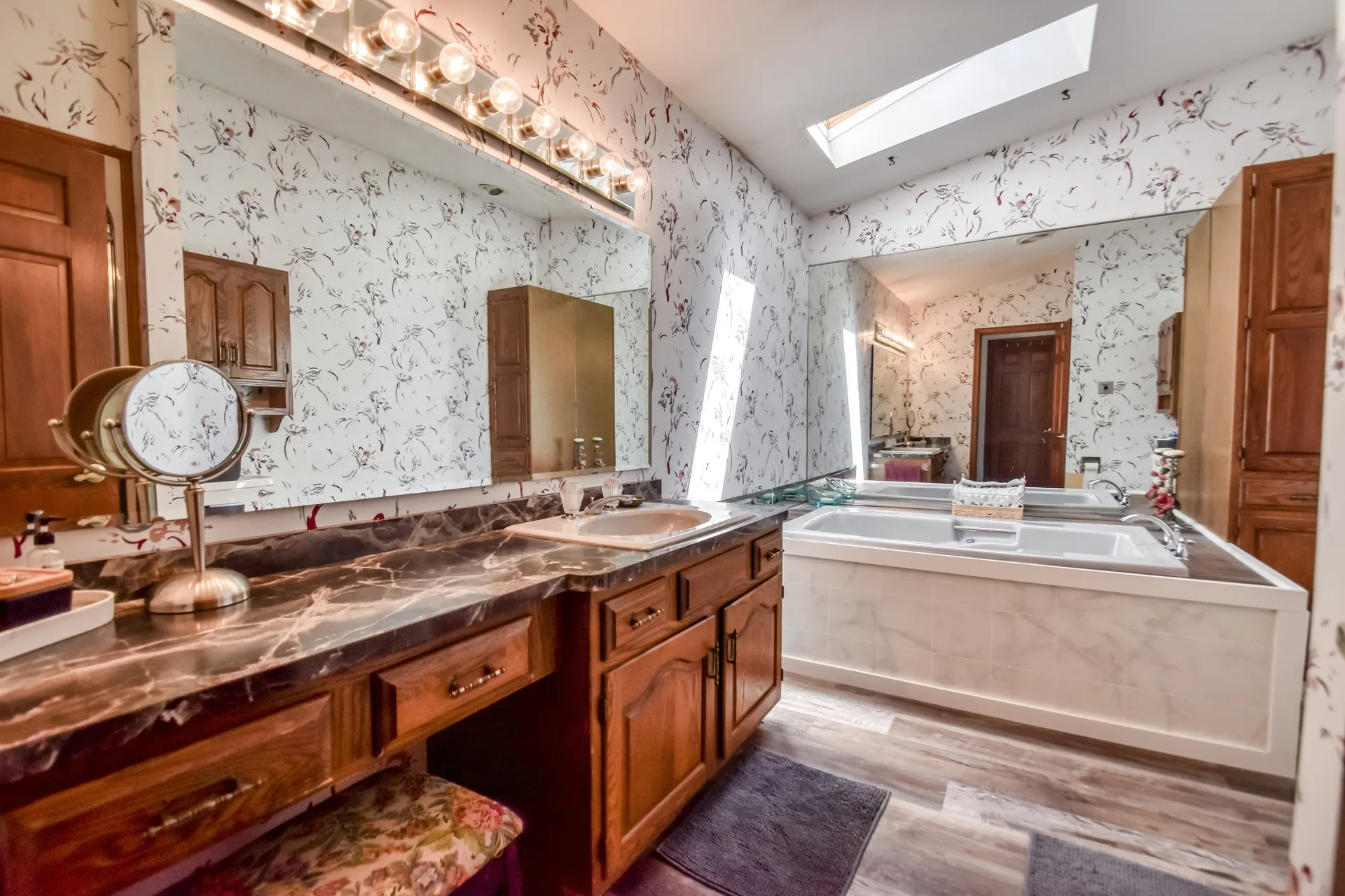 Primary bathroom with marble vanity and soaking tub