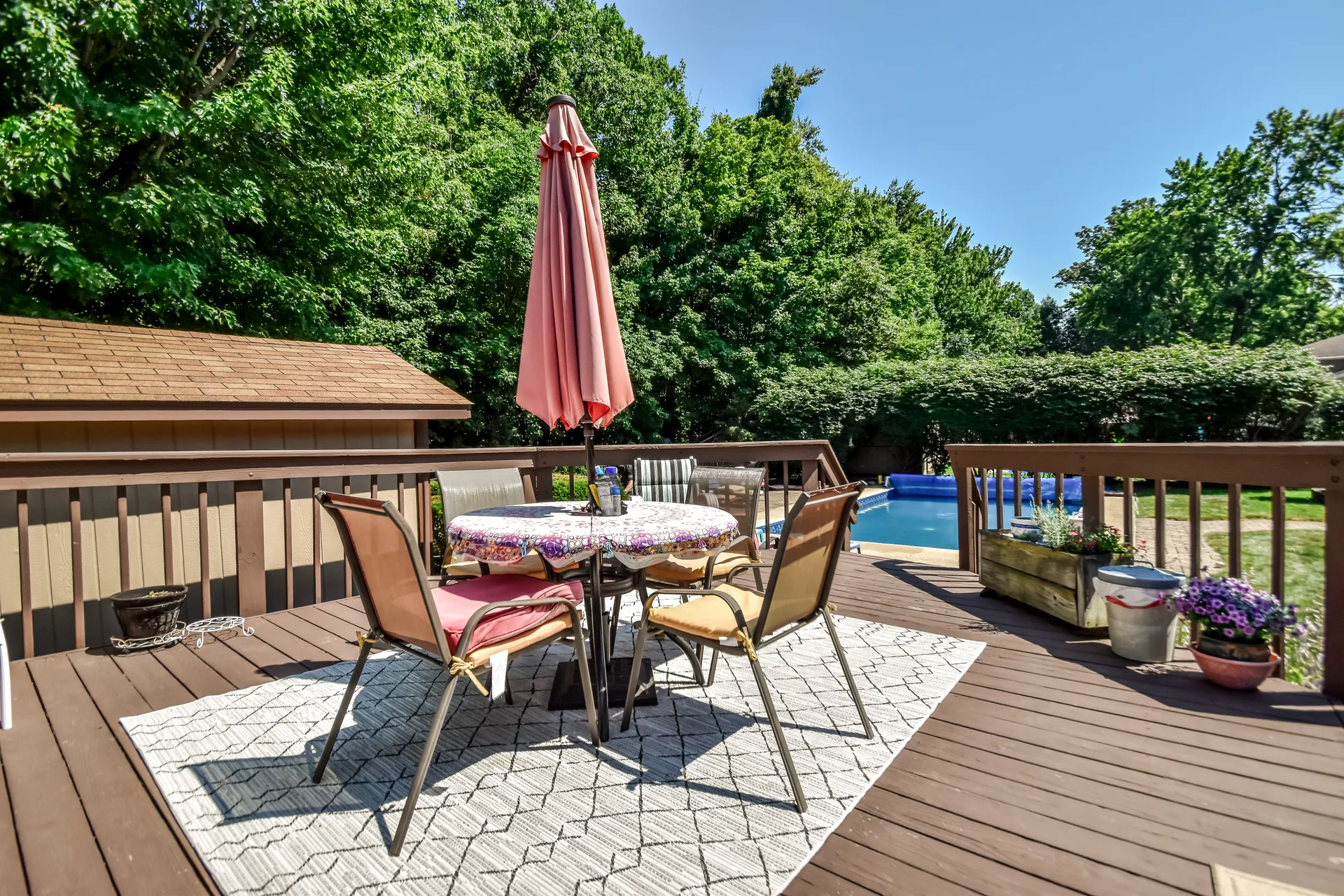 Deck overlooking in-ground swimming pool