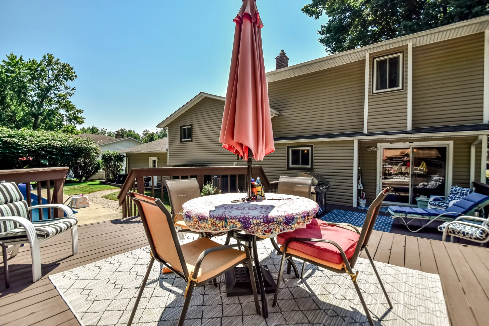 Wooden deck with dining set and view of home exterior