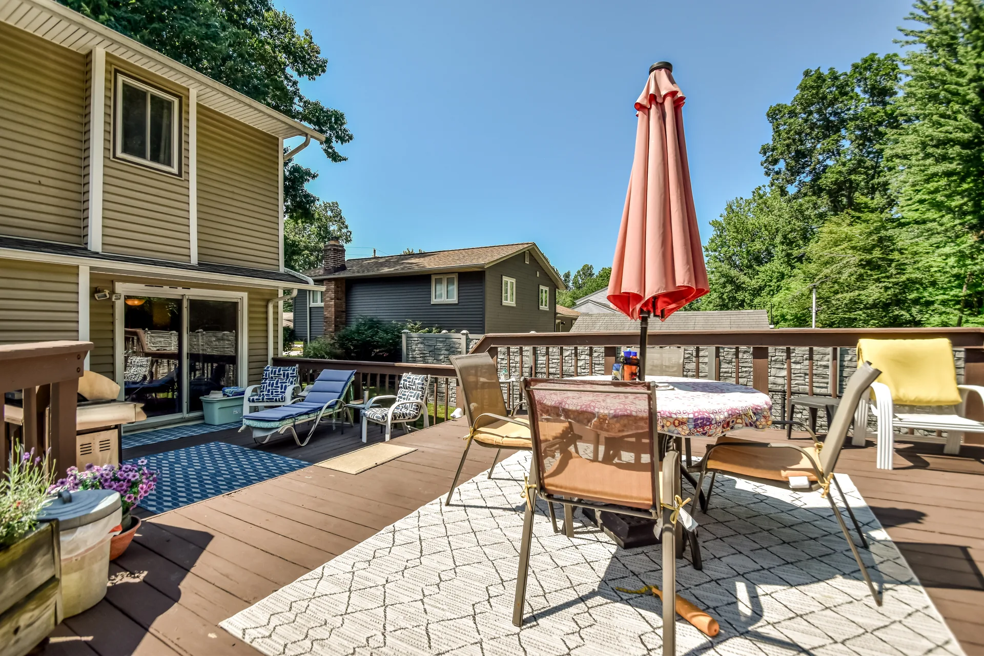 Elevated wooden deck with dining table and umbrella