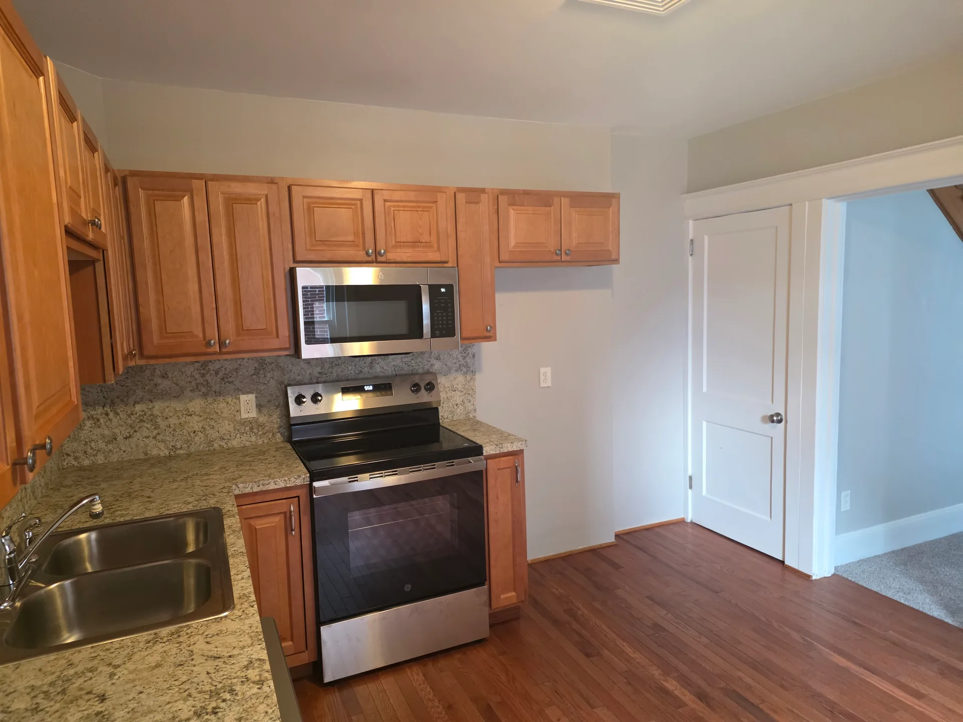 Kitchen with honey-oak cabinets and stainless steel appliances